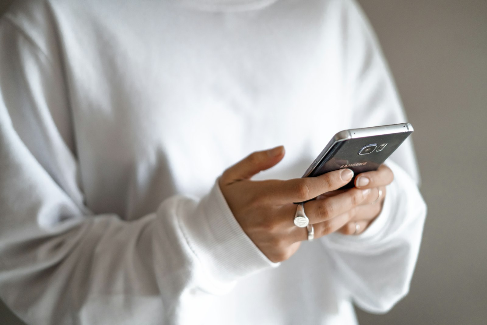 A hand holding a phone with a message on it