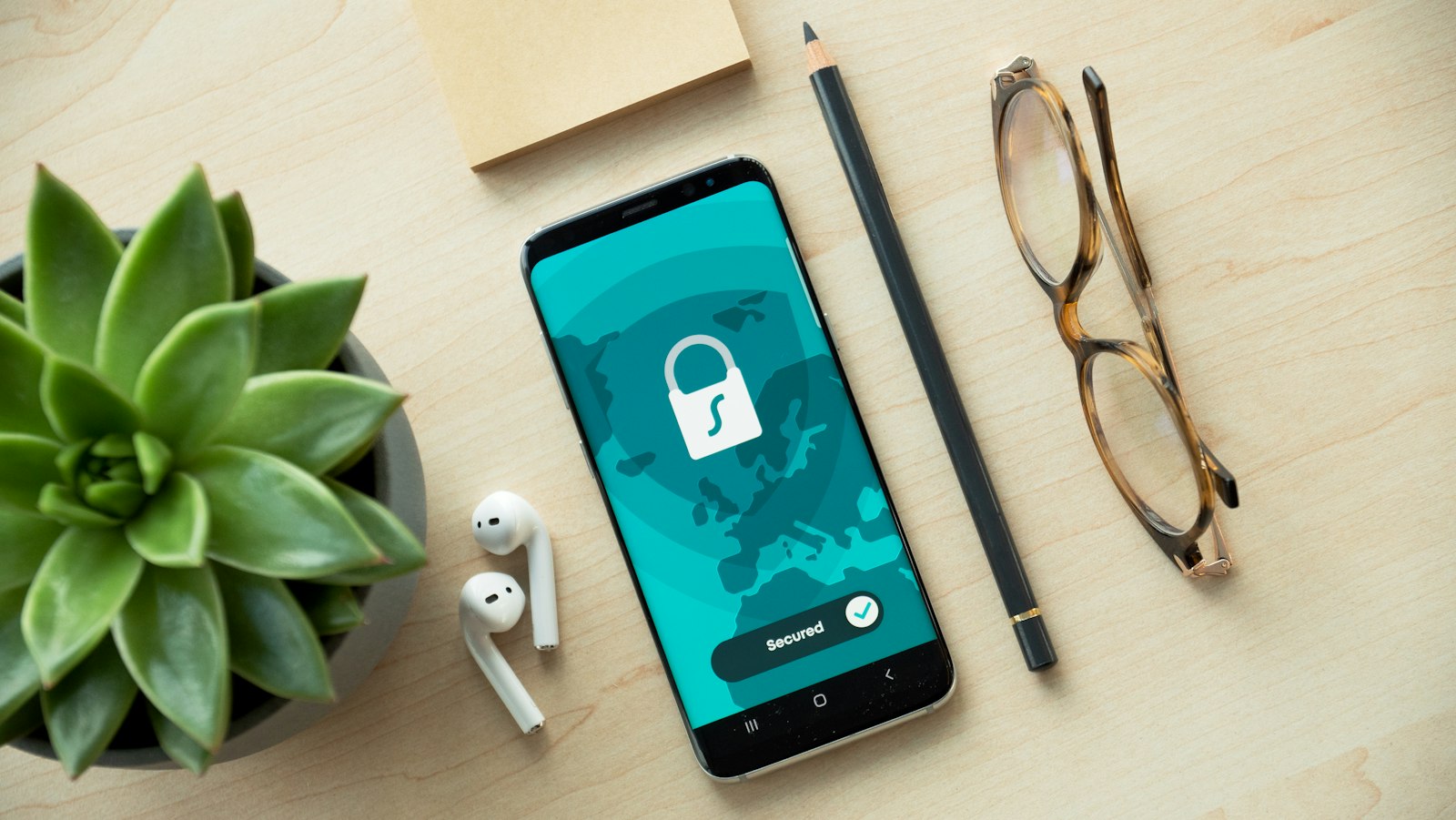 A phone on a desk showing a lock icon